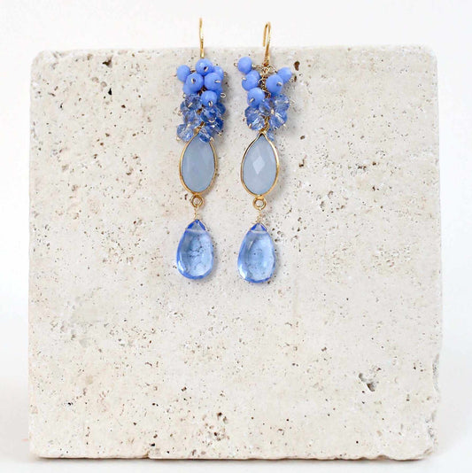 Dark Blue Chalcedony Bezel Cluster EarringsDripping in gems, these long drop earrings are made with a dark blue chalcedony bezel and sky blue quartz gemstones.- 2.5" long- French hooks- 14k gold plated .925 fEarringsPARKEN JEWELRYVettedArcDark Blue Chalcedony Bezel