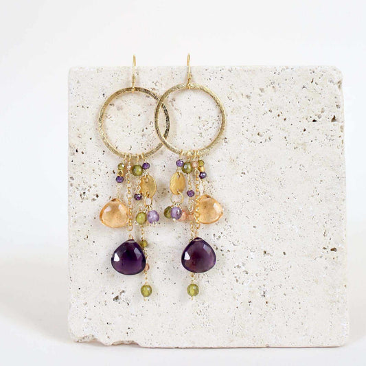 Amethyst & Citrine Ammil EarringsMultiple strands of lush gems sparkle on a 1" hoop.
- Amethyst and Citrine gemstones- 3.5" long- French hooks- 14k gold plated .925 fine Italian sterling silver- MadEarringsPARKEN JEWELRYVettedArcAmethyst & Citrine Ammil Earrings