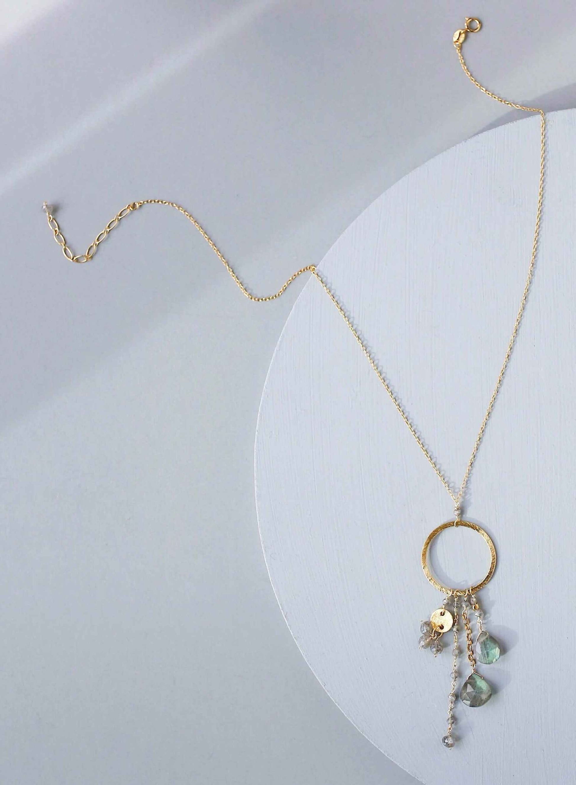 The Ammil Necklace featuring a lush labradorite gemstone pendant with multiple gemstone strands on a 14k gold plated hoop, handmade in New York City.