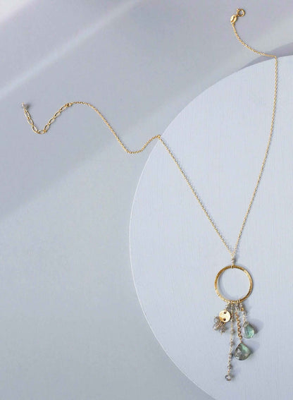The Ammil Necklace featuring a lush labradorite gemstone pendant with multiple gemstone strands on a 14k gold plated hoop, handmade in New York City.