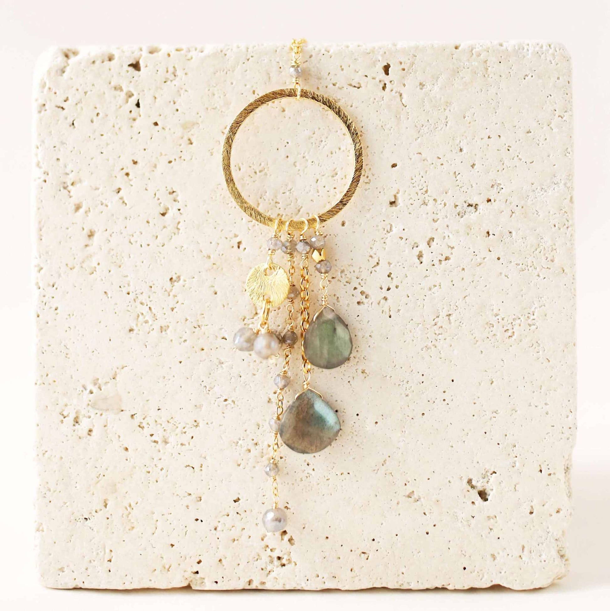 The Ammil Necklace featuring a labradorite gemstone pendant with multi-strand combinations on a 14k gold plated hoop