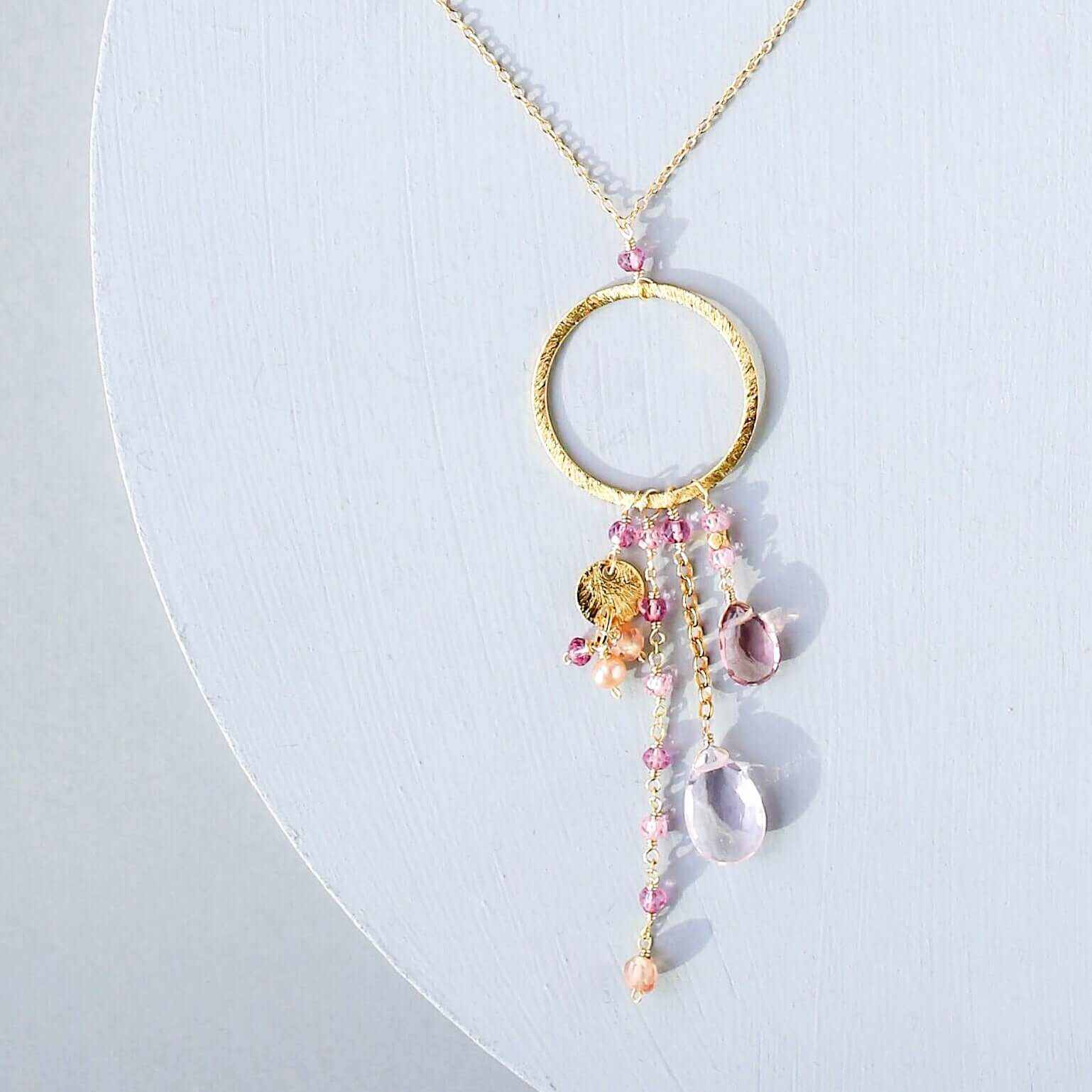 The Ammil Necklace with rose pink gemstones and gold hoop pendant