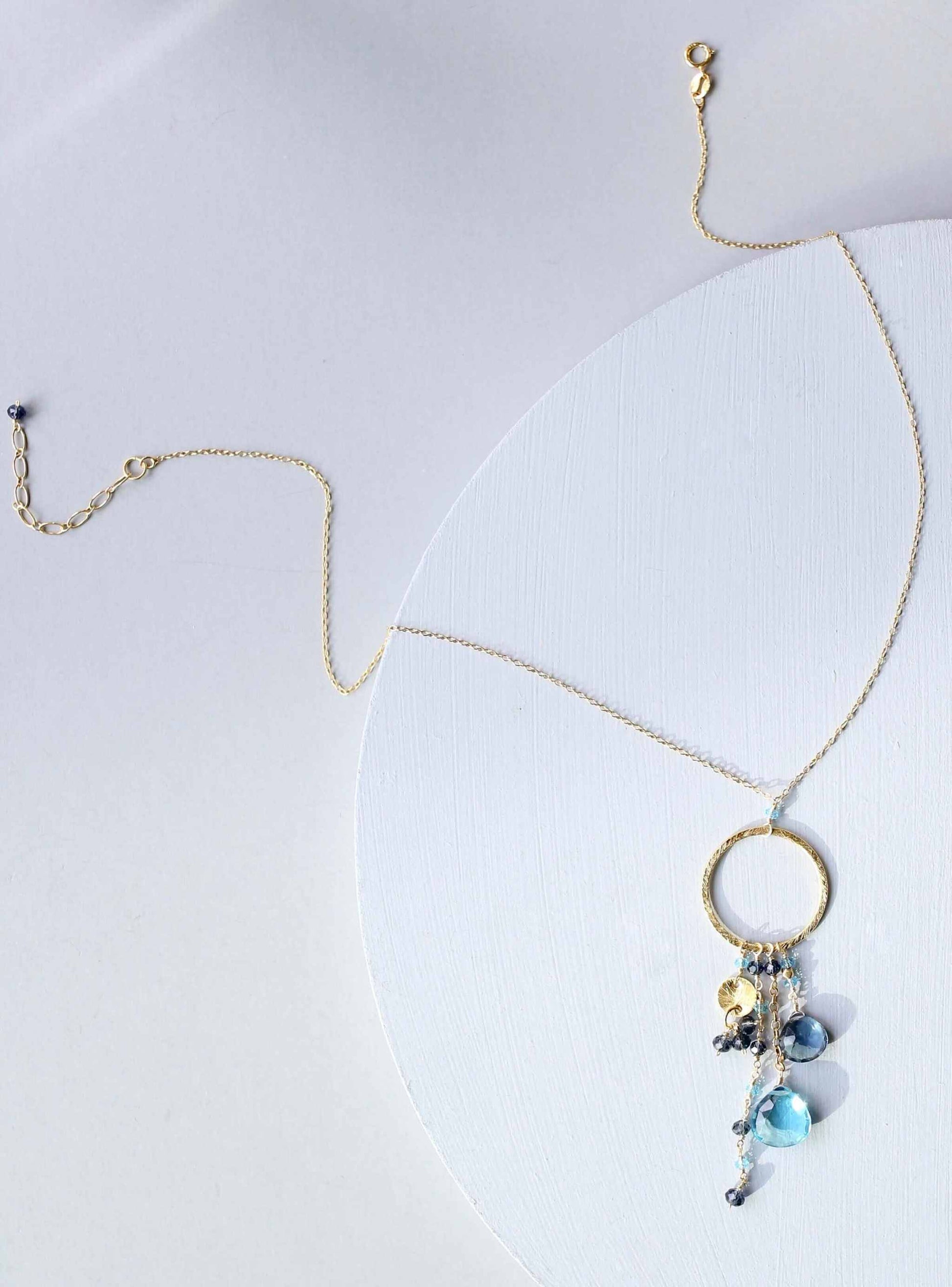Aquamarine and iolite ammil necklace with gold hoop and multi-strand gemstones