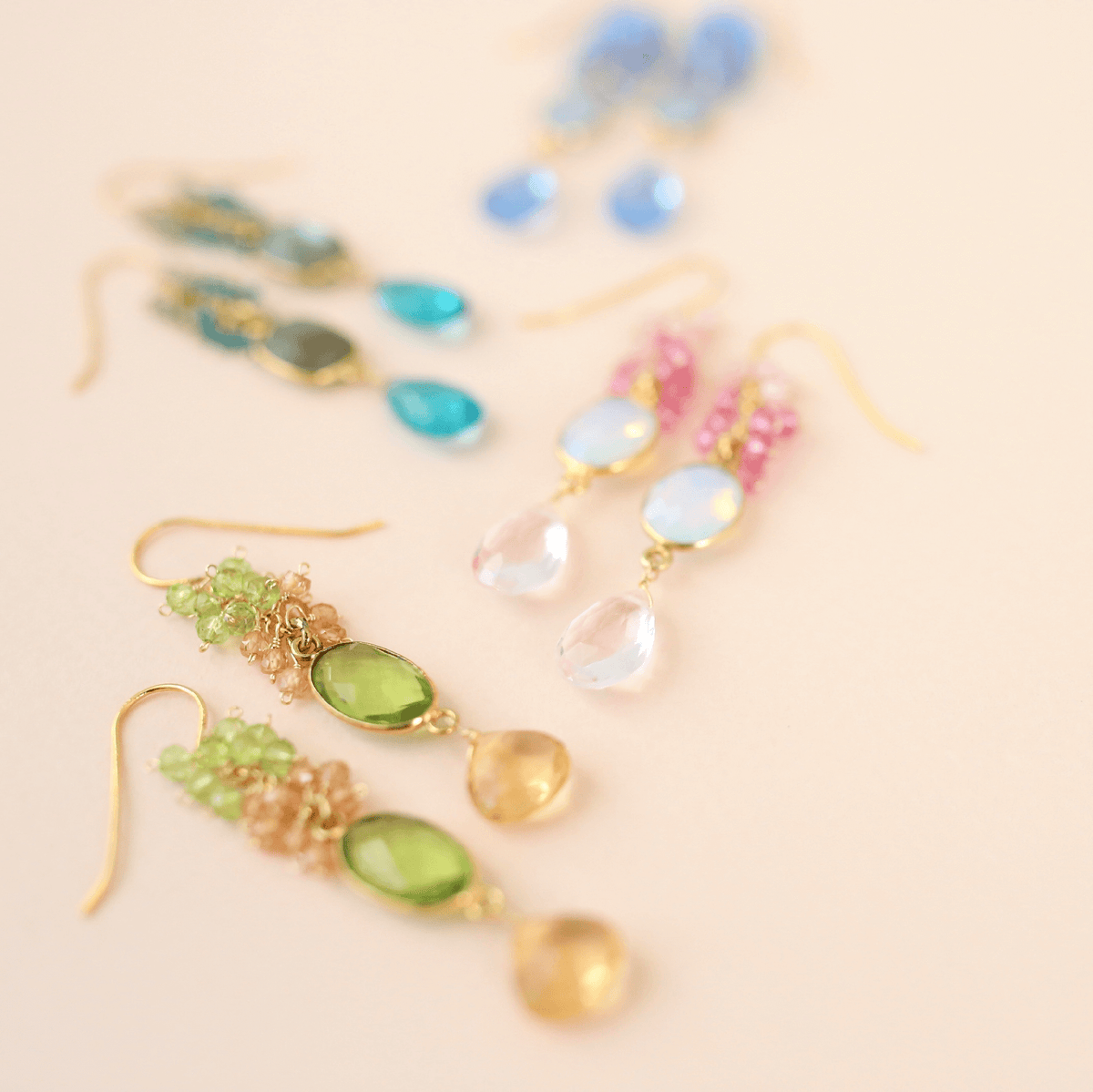 Bezel Cluster EarringsDripping in gems, these long gemstone drop earrings are a handmade combination of beautiful bezel set stones and clusters of gems.- 2.5" long- French hooks- 14k goldEarringsPARKEN JEWELRYVettedArcBezel Cluster Earrings