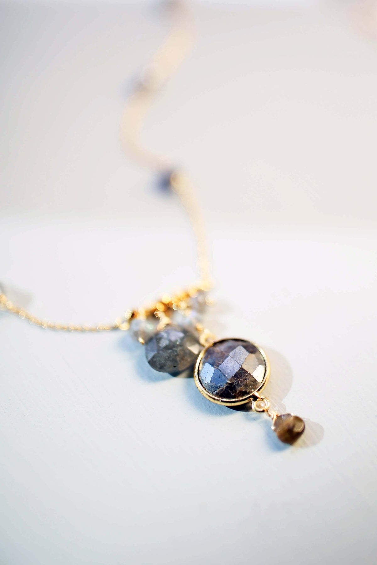 Gold bezel necklaces with labradorite and other gemstones on delicate chains