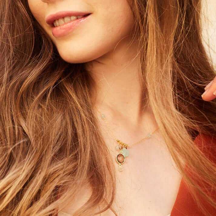 Gold bezel necklaces with gemstone pendants on delicate chains