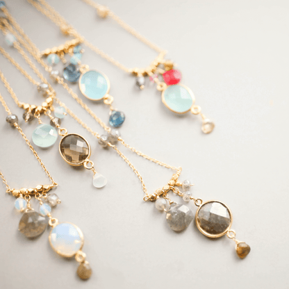 Elegantly crafted bezel necklaces with various bezel set gemstones on delicate gold chains