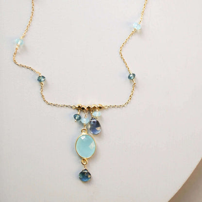 Delicate bezel necklaces with various bezel set gemstones on gold chains.