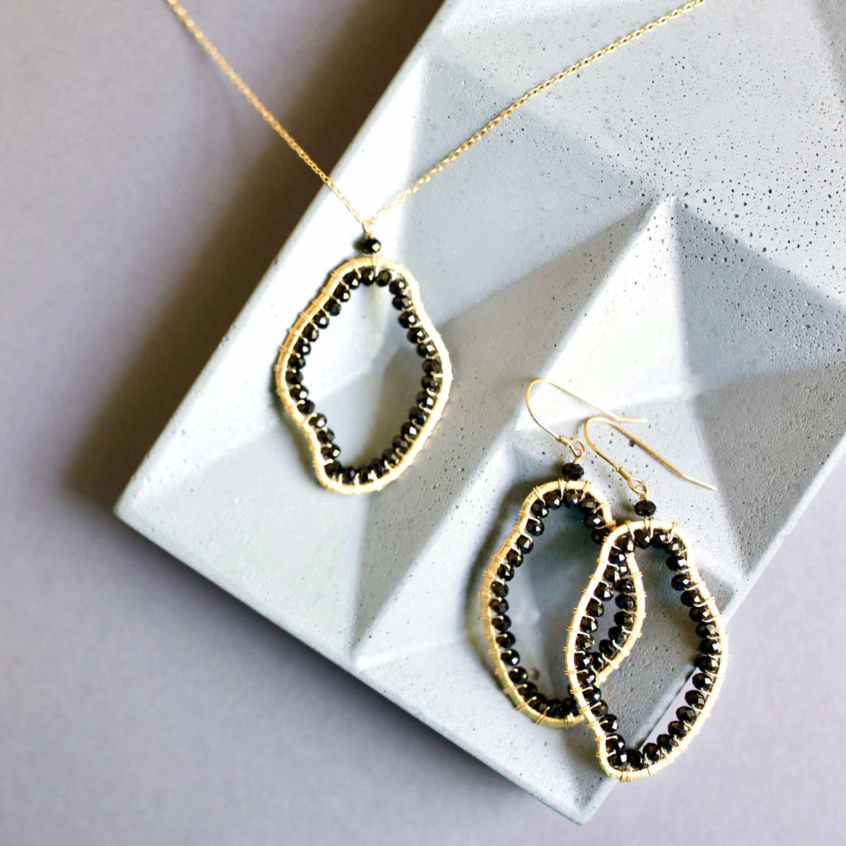 Black Spinel freestyle pendant necklace on delicate gold chain with abstract unique shape