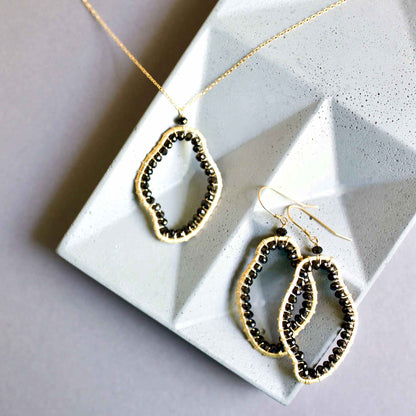Black Spinel freestyle pendant necklace on delicate gold chain with abstract unique shape