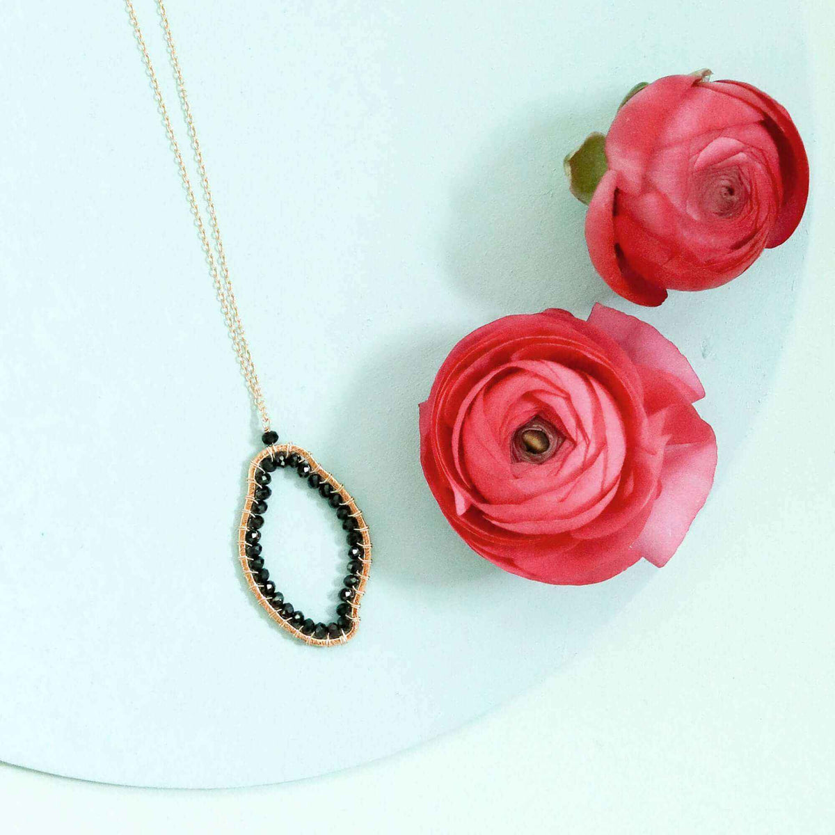 Black Spinel freestyle pendant necklace with unique abstract design on delicate gold-plated sterling silver chain