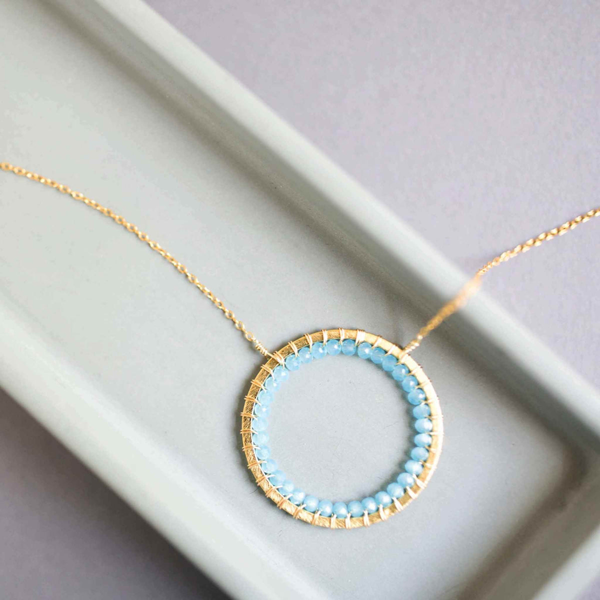 Blue Chalcedony Halo Necklace with 14k gold plated silver chain and floating pendant design