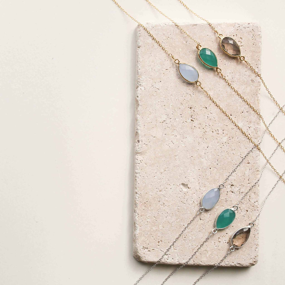 Gold and silver minimalist gemstone necklaces with bezel set stones, perfect for layering and everyday luxury.
