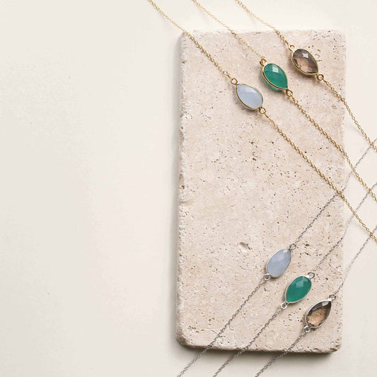 Gold and silver minimalist gemstone necklaces with bezel set stones, perfect for layering and everyday luxury.