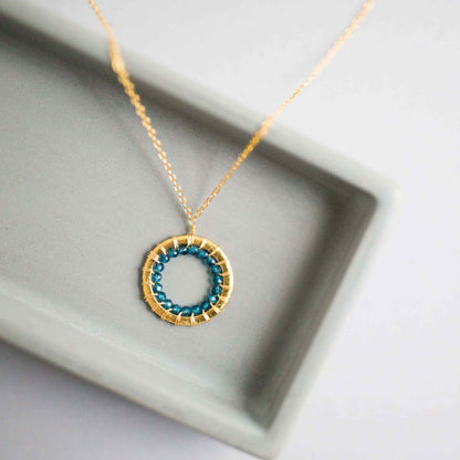 Close-up of Halo Mini Gold Pendant necklace with sparkling gems on adjustable 14k gold plated silver chain