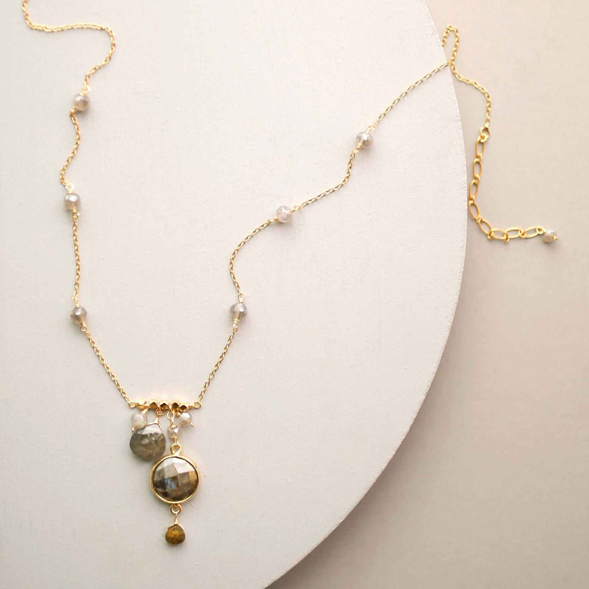 Labradorite bezel necklace with gold chain and accent stones on gift box