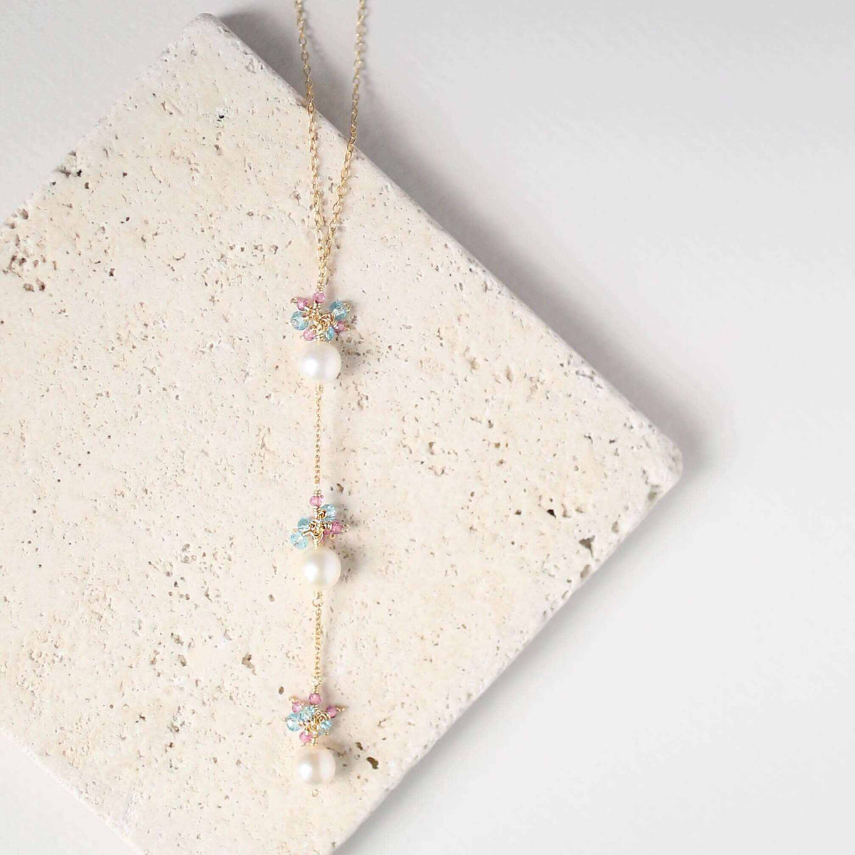 Pearl and Aquamarine Quartz NecklaceY design with 3 white freshwater bead pearls paired with genuine aquamarine quartz  gemstones.
Handmade necklace is 18" long with a 2" extender (up to 20") and 14k gNecklacesPARKEN JEWELRYVettedArcPearl And Aquamarine Quartz Necklace