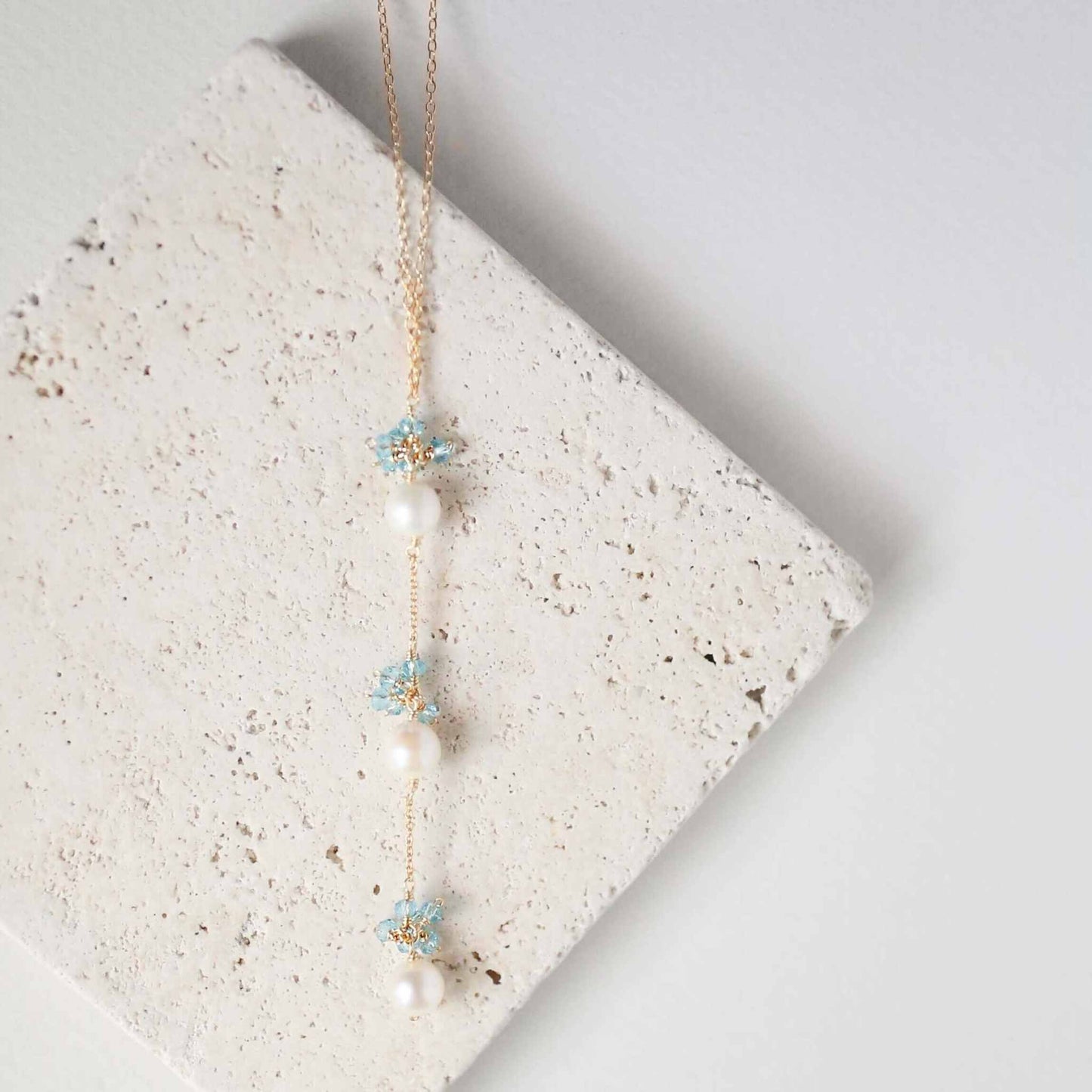 Pearl and Aquamarine Quartz NecklaceY design with 3 white freshwater bead pearls paired with genuine aquamarine quartz  gemstones.
Handmade necklace is 18" long with a 2" extender (up to 20") and 14k gNecklacesPARKEN JEWELRYVettedArcPearl And Aquamarine Quartz Necklace