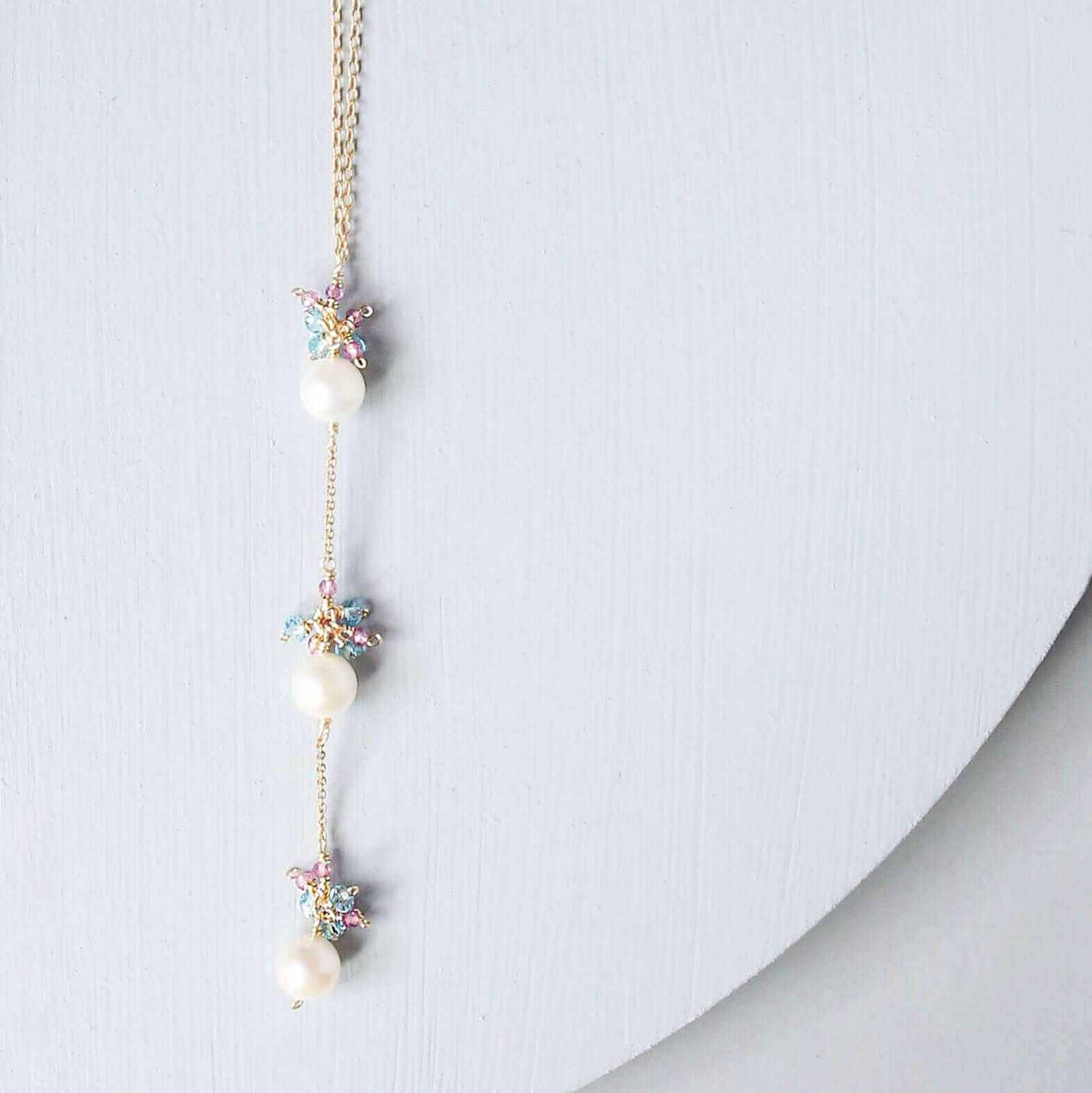 Pearl and Aquamarine Quartz NecklaceY design with 3 white freshwater bead pearls paired with genuine aquamarine quartz  gemstones.
Handmade necklace is 18" long with a 2" extender (up to 20") and 14k gNecklacesPARKEN JEWELRYVettedArcPearl And Aquamarine Quartz Necklace