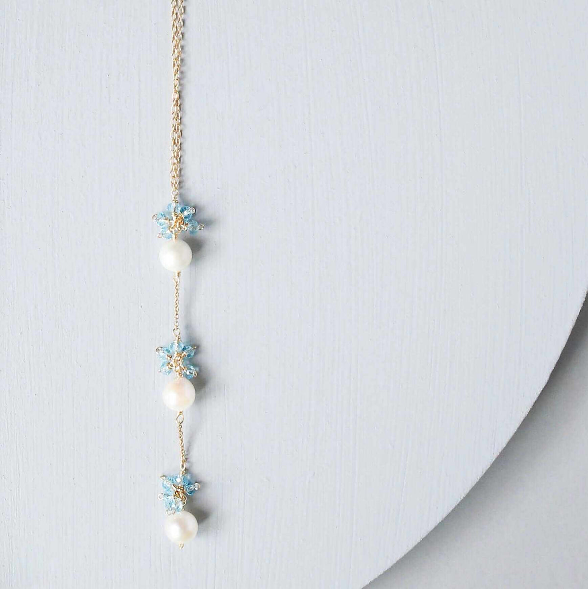 Pearl and Aquamarine Quartz NecklaceY design with 3 white freshwater bead pearls paired with genuine aquamarine quartz  gemstones.
Handmade necklace is 18" long with a 2" extender (up to 20") and 14k gNecklacesPARKEN JEWELRYVettedArcPearl And Aquamarine Quartz Necklace