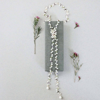 Pearl and gemstone ballet lariat necklace with freshwater pearls and multicolored gemstones on white background