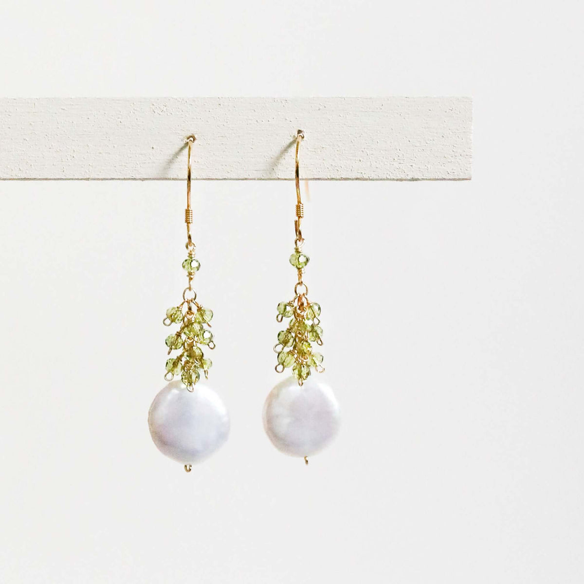 Peridot coin pearl earrings with freshwater pearls and peridot gemstones, 1.25" long, 14k gold plated sterling silver, French hooks, handmade in NYC.