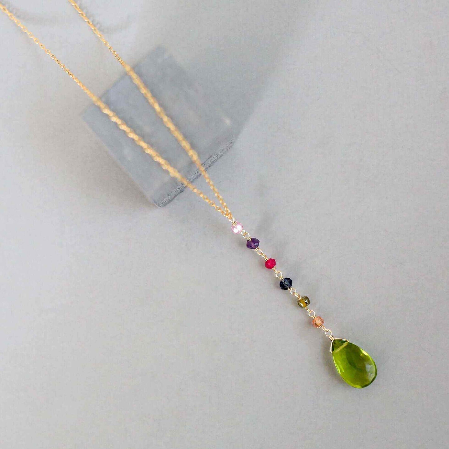 Peridot green quartz yoga pendant necklace in gold with multicolor accent stones