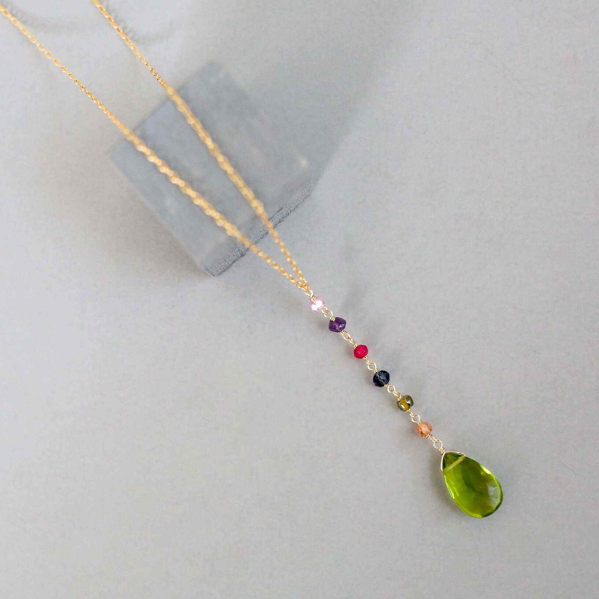 Peridot green quartz yoga pendant necklace in gold with multicolor accent stones