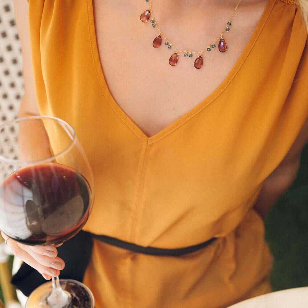 Close-up of Rhodolite Garnet Sparkler Necklace with deep purple garnet and blue aquamarine on 14k gold plated silver chain