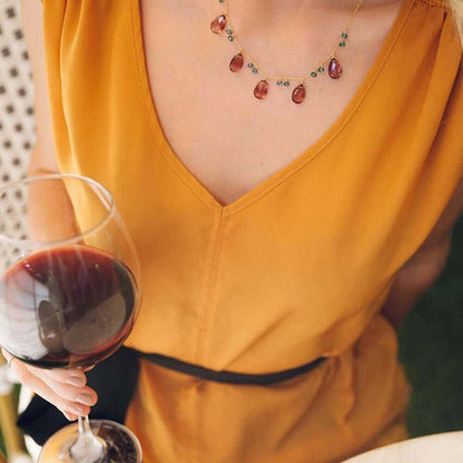 Close-up of Rhodolite Garnet Sparkler Necklace with deep purple garnet and blue aquamarine on 14k gold plated silver chain