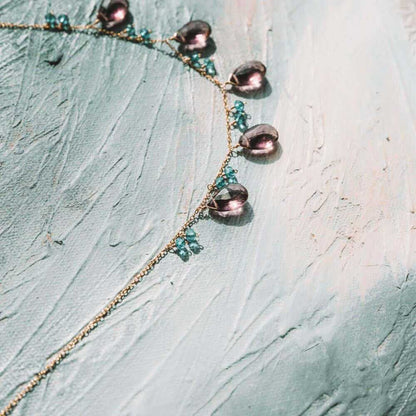 Rhodolite garnet and aquamarine sparkler necklace with 14k gold plated chain on white background