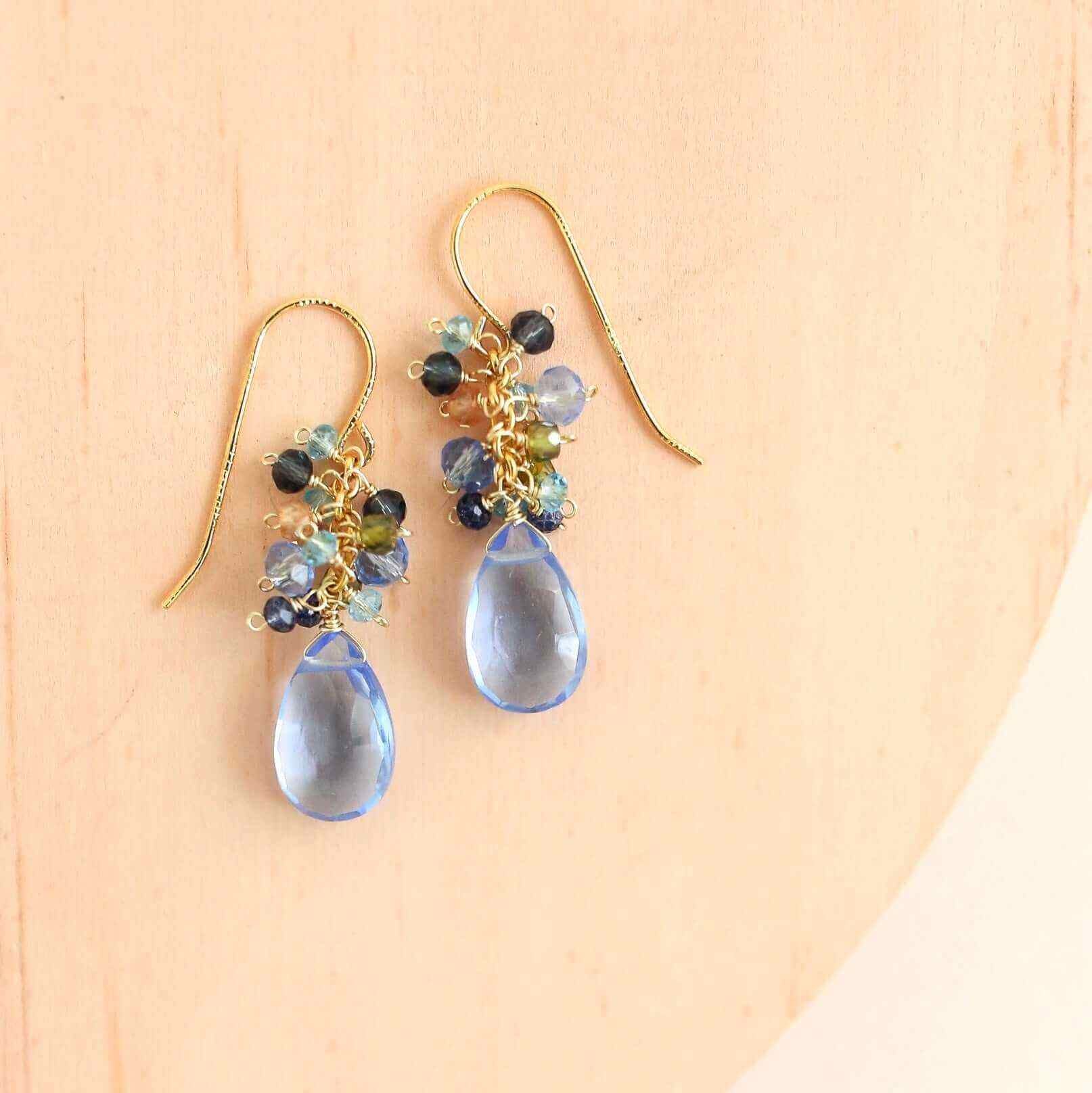 Sky Blue Quartz Bala EarringsStunning drops of color. Gold drop earrings made with sky blue quartz topped with a blue cluster of gems.
- 1.25" long- French hooks- 14k gold plated .925 fine ItaliEarringsPARKEN JEWELRYVettedArcSky Blue Quartz