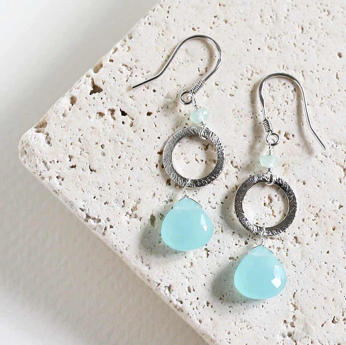 The Airie Earring featuring blue chalcedony gemstones with rhodium plated silver French hooks