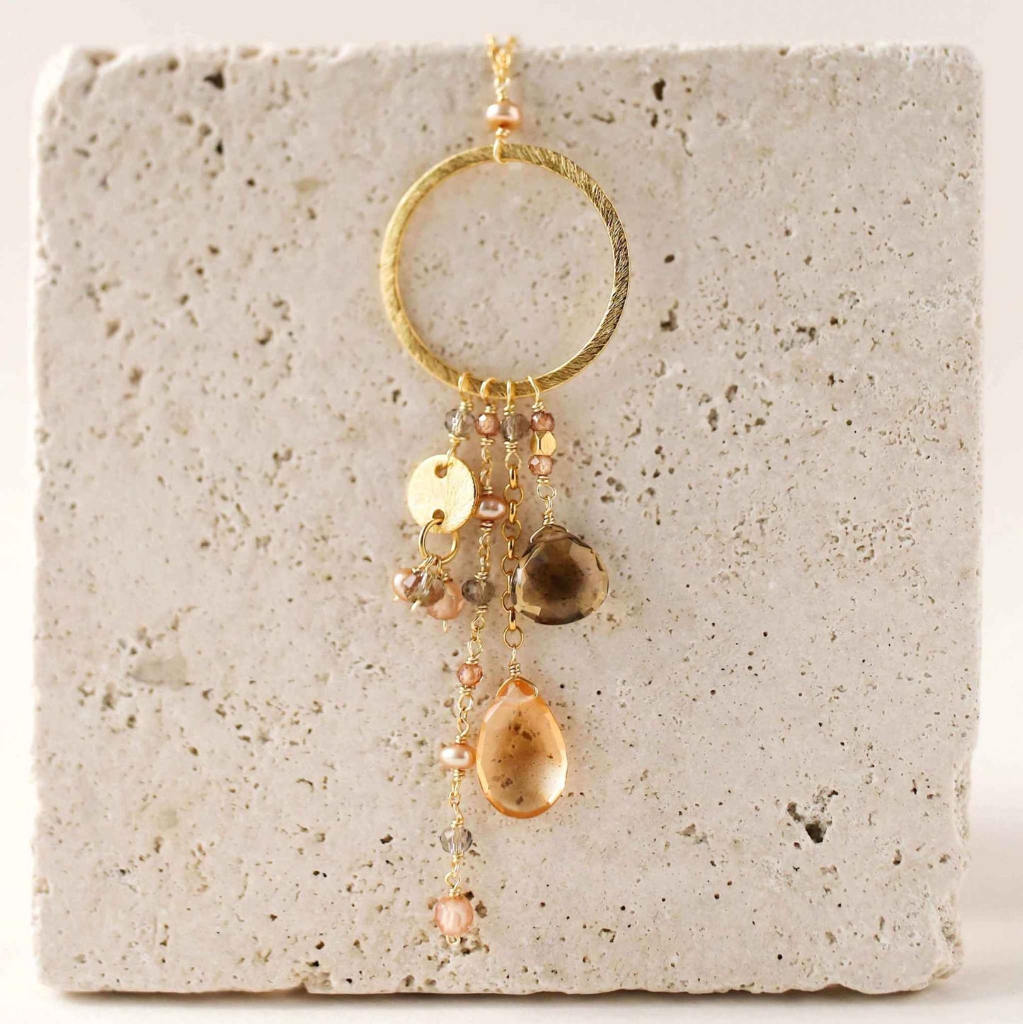 The Ammil Necklace with citrine and smoky quartz strands on a 14k gold plated sterling silver hoop