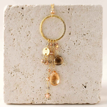 The Ammil Necklace with citrine and smoky quartz strands on a 14k gold plated sterling silver hoop