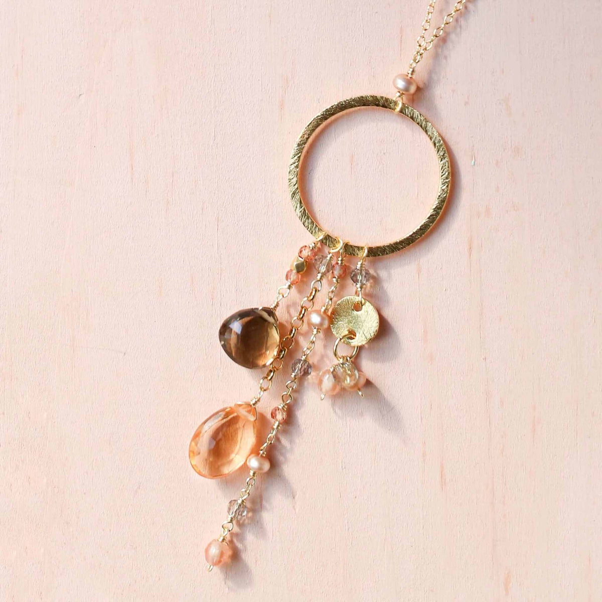 The Ammil Necklace with citrine and smoky quartz strands on a gold hoop, 14k gold plated sterling silver, handmade in NYC